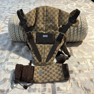 Designer GG baby carrier and bottle holder.